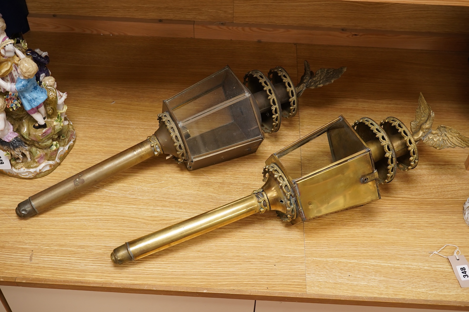 A pair of brass coaching lamps with eagle mounts, 75cm high